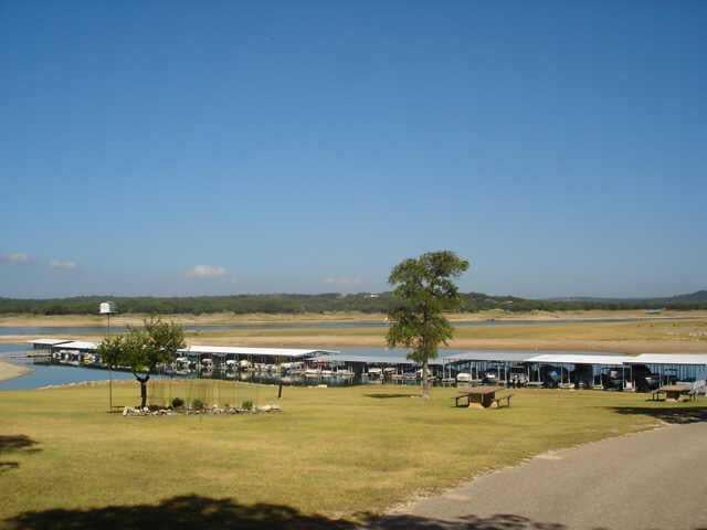View 21505 Santa Carlo Ave 21505 Santa Carlo Ave - front exterior - Luxury lot in Lago Vista, TX