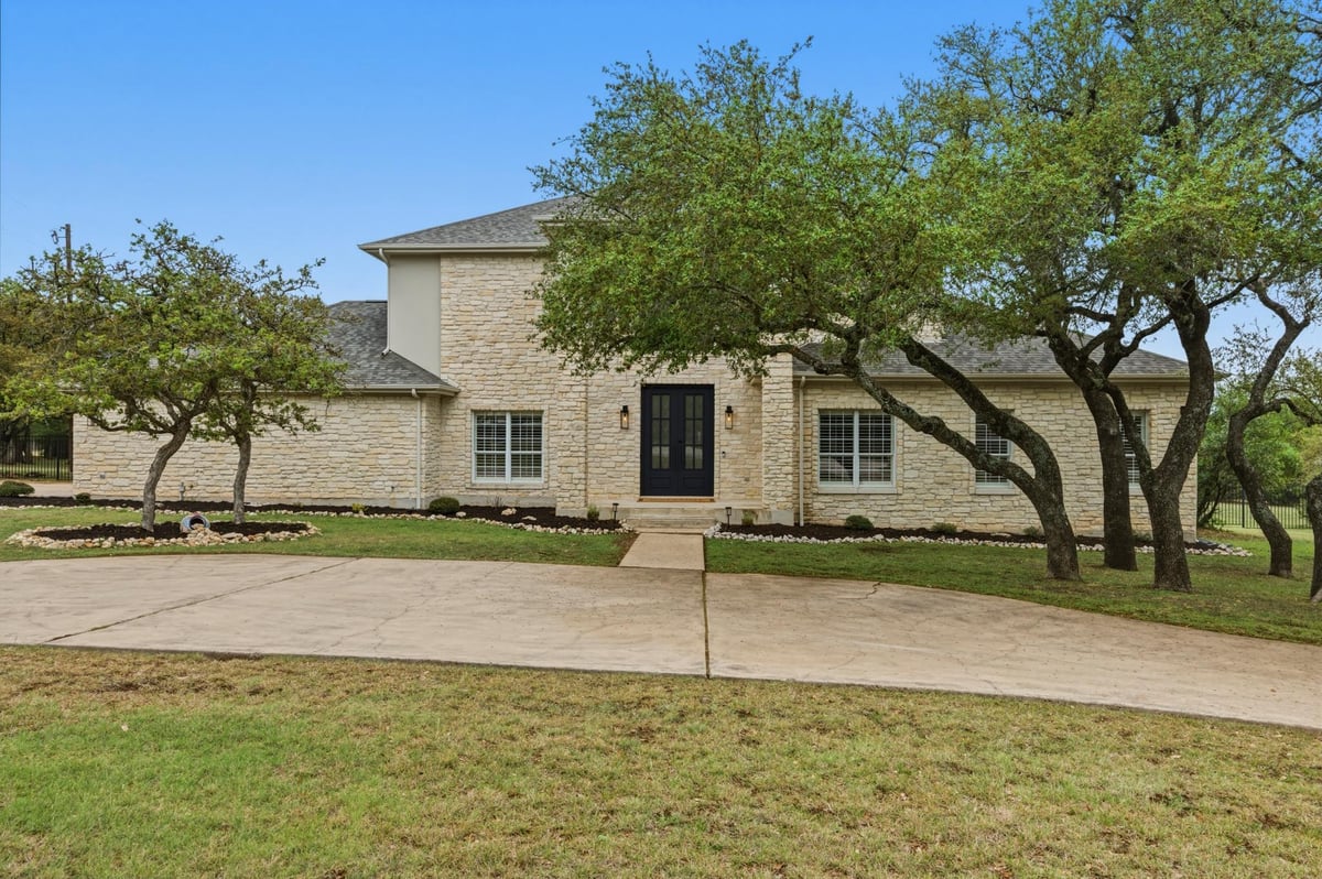 View 900 Canyonwood DR in Sunset Canyon Sec V 900 Canyonwood DR - front exterior - Luxury home in Sunset Canyon Sec V, Dripping Springs, TX