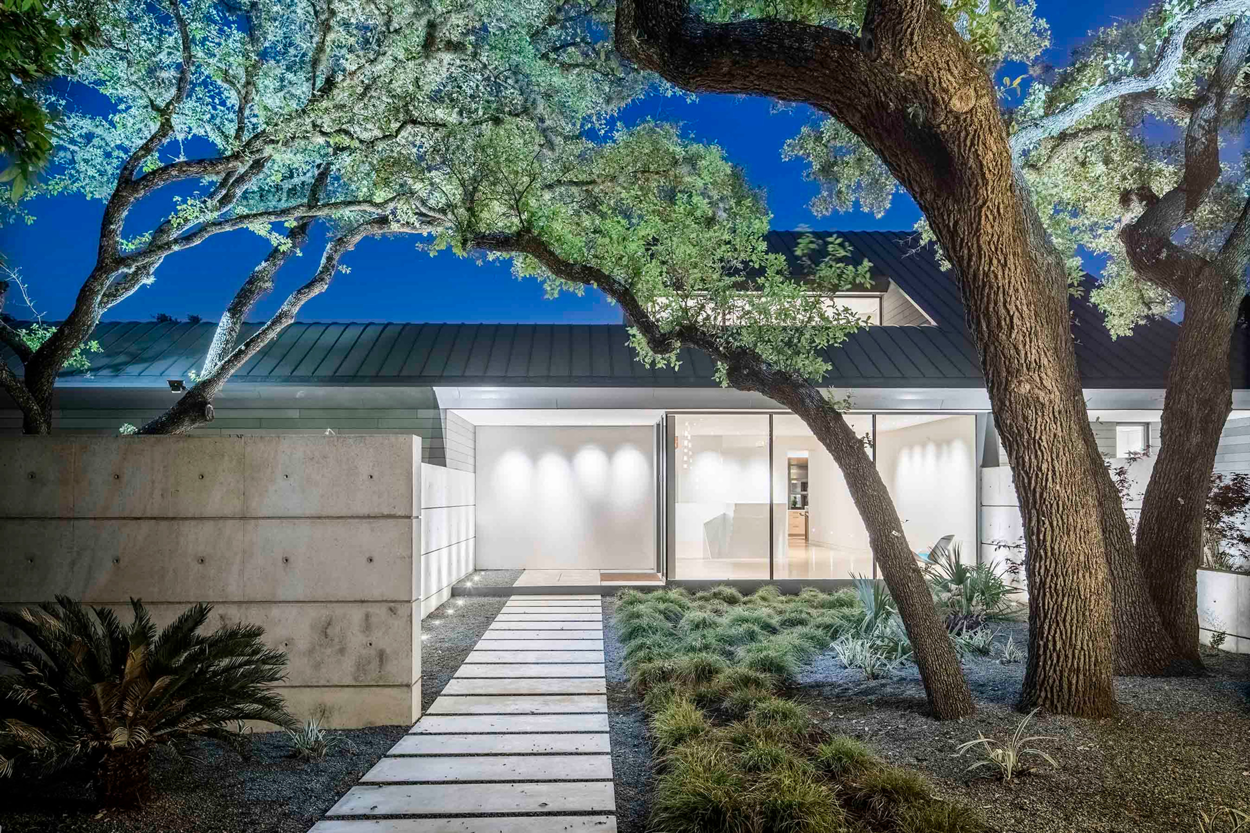 East elevation with floor-to-ceiling German windows and steel fencing