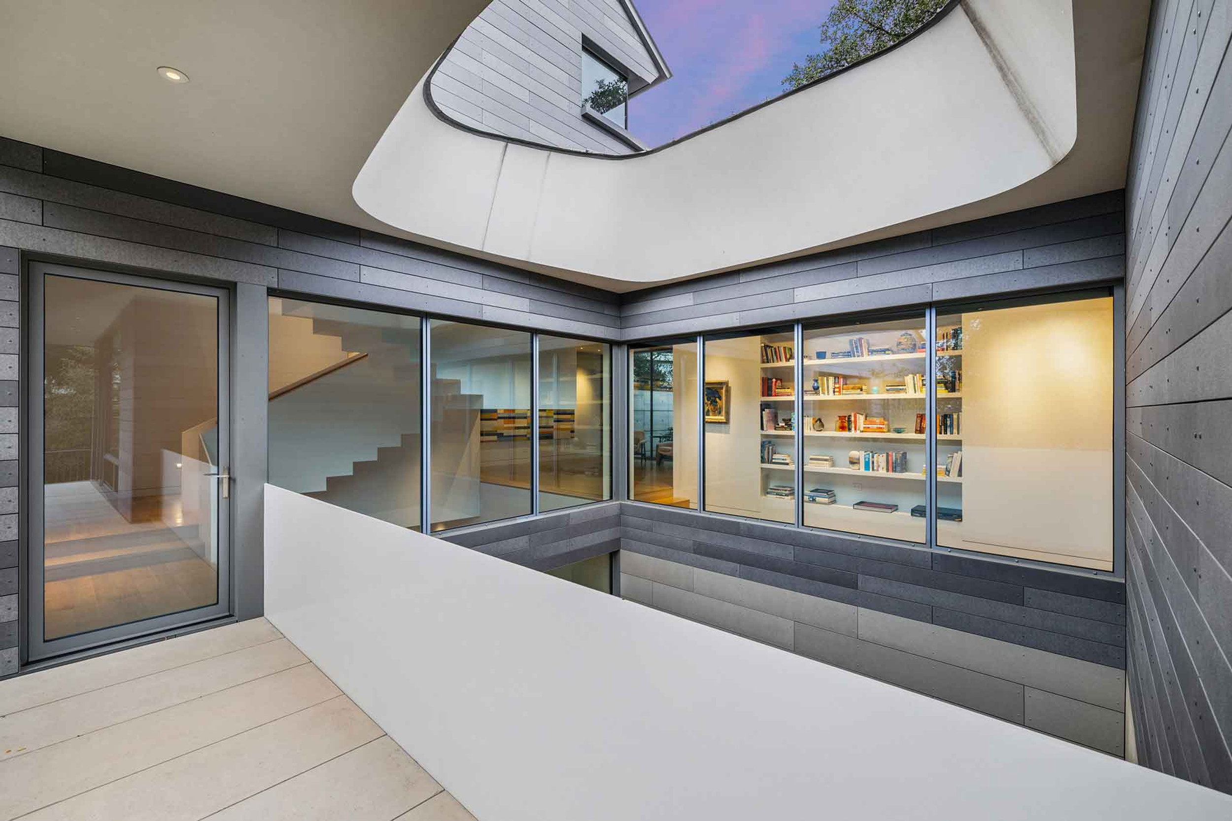 Two-story Zen courtyard with Oculus roof light
