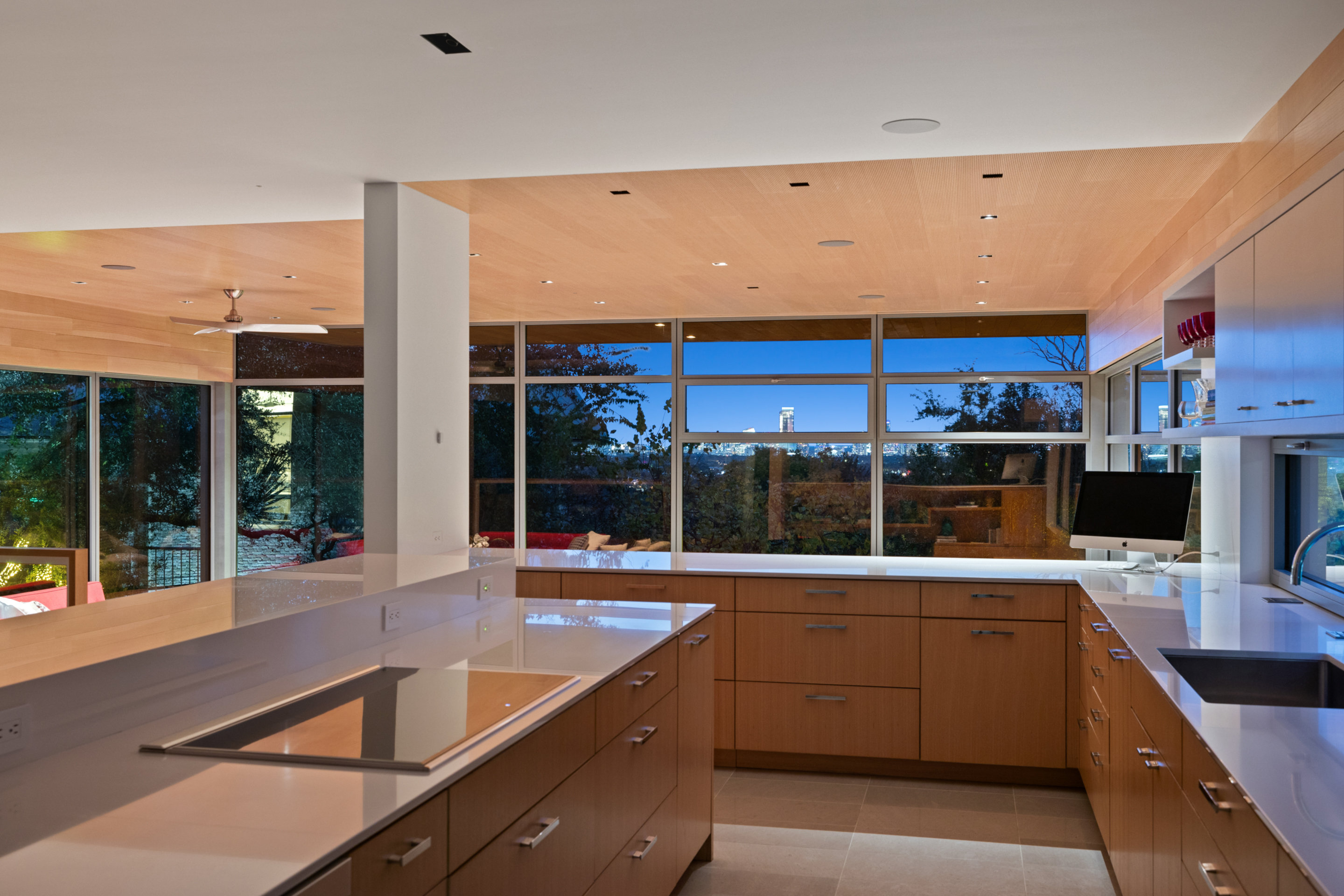 Living area with red upholstery accent and views to courtyard garden