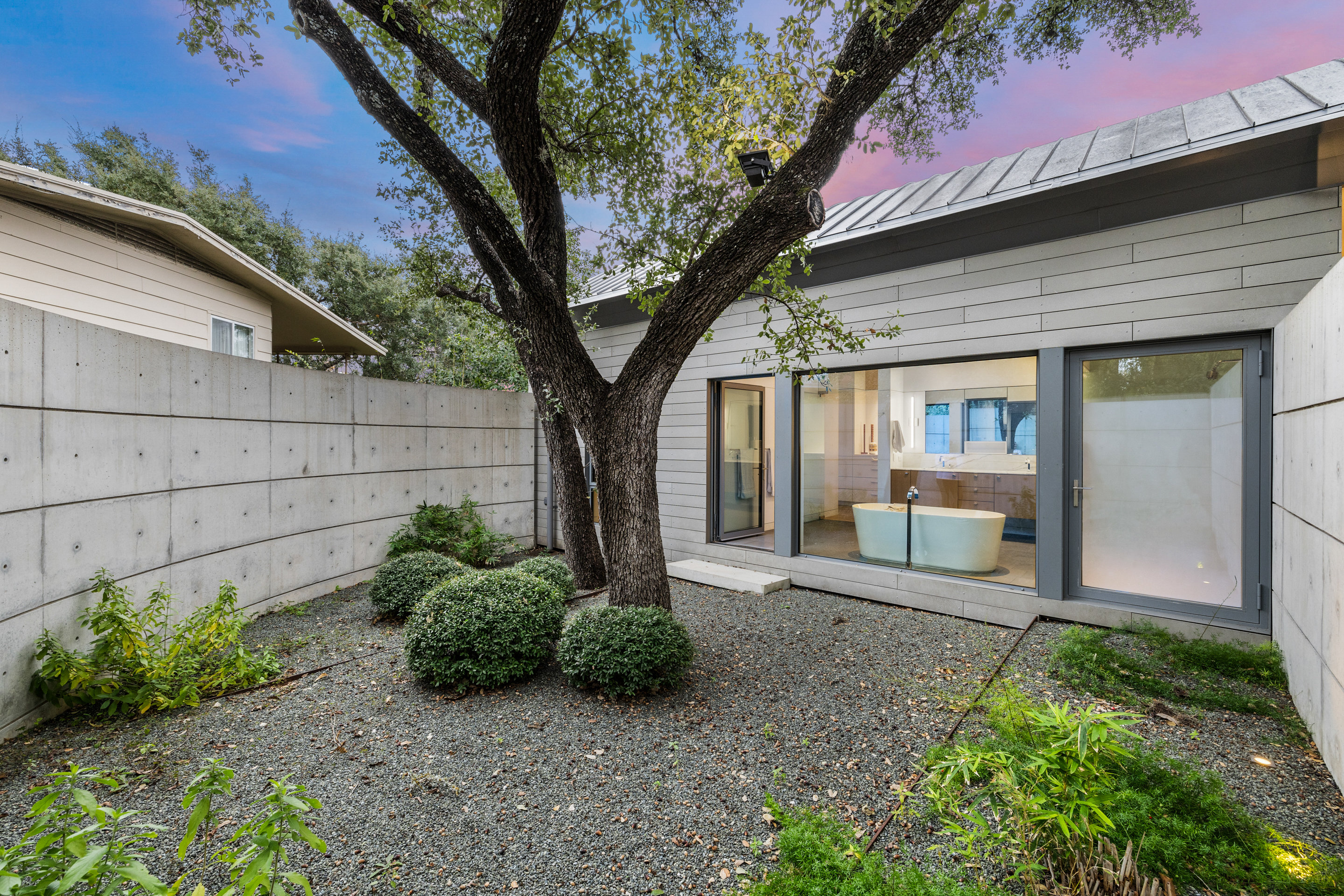Entry garden with concrete wall and native landscaping by Sitio Design
