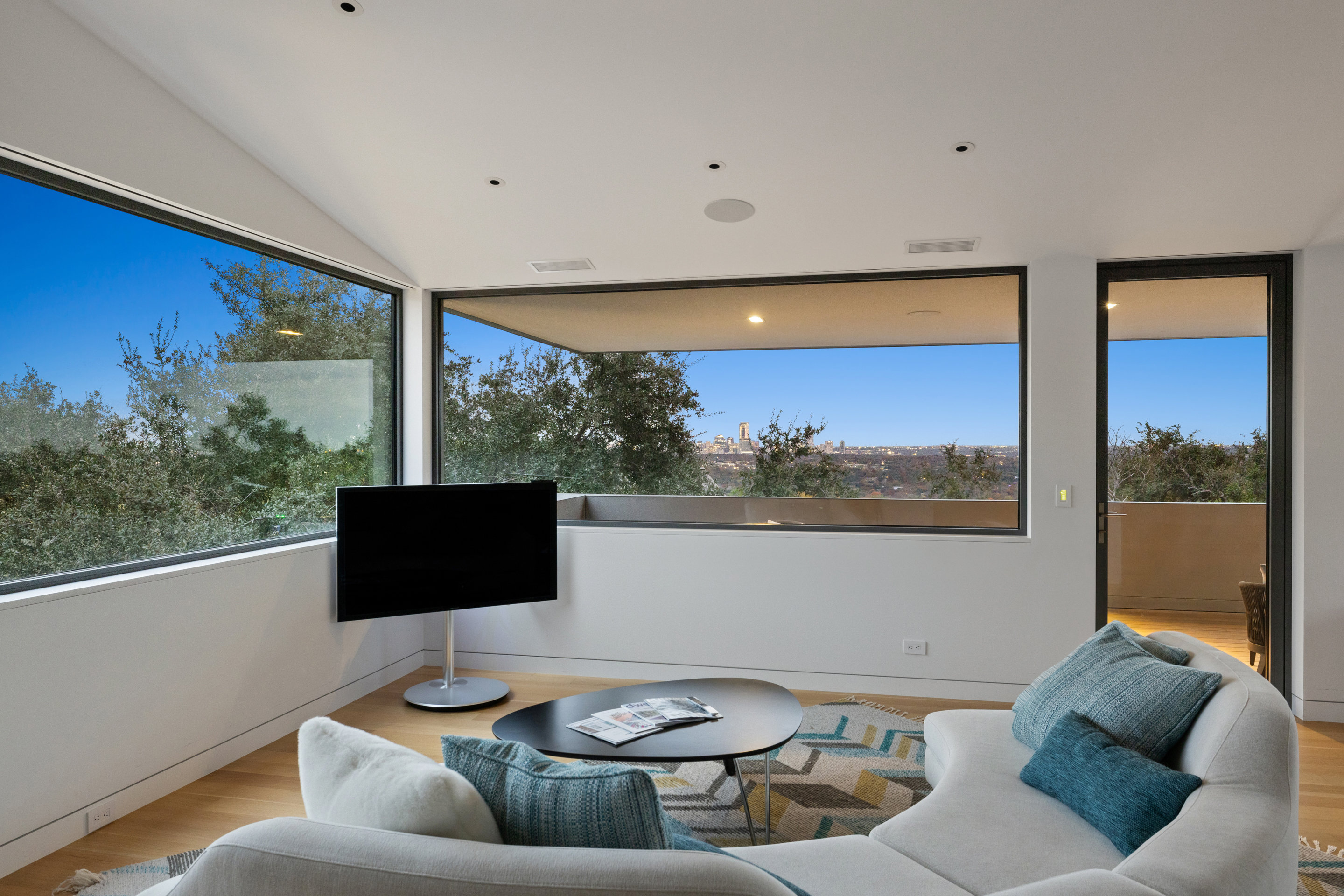 Main level living space with double-height ceilings and natural light