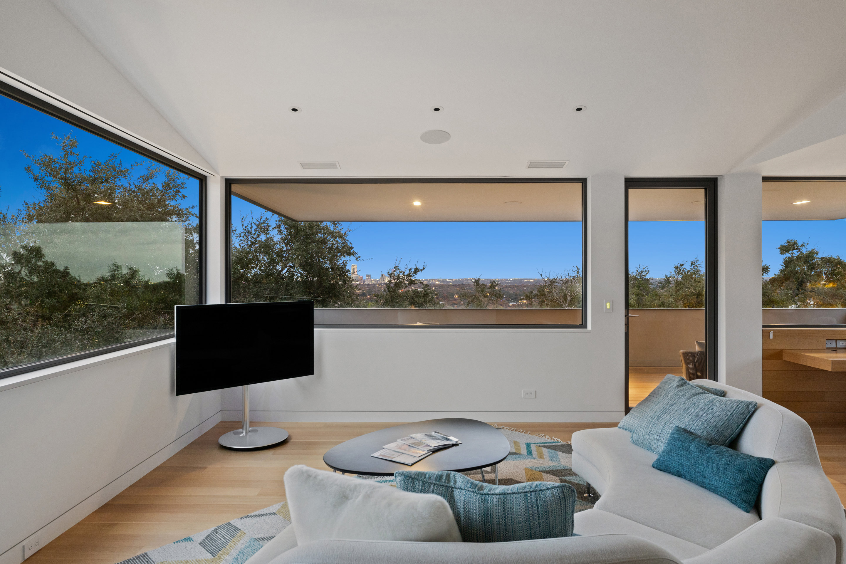 Living space flowing into kitchen with white oak millwork throughout