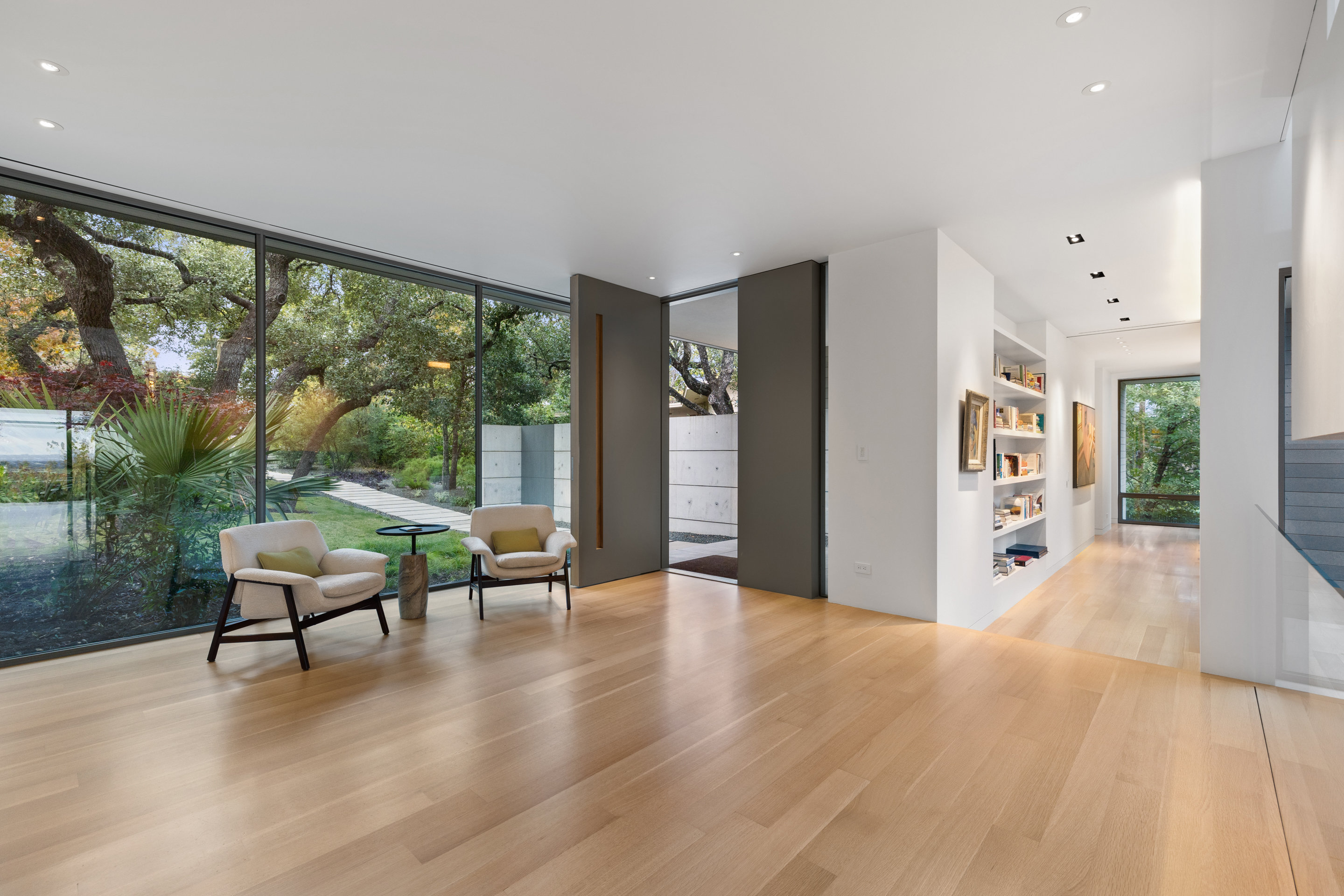 Staircase from entry level looking up through double-height volume