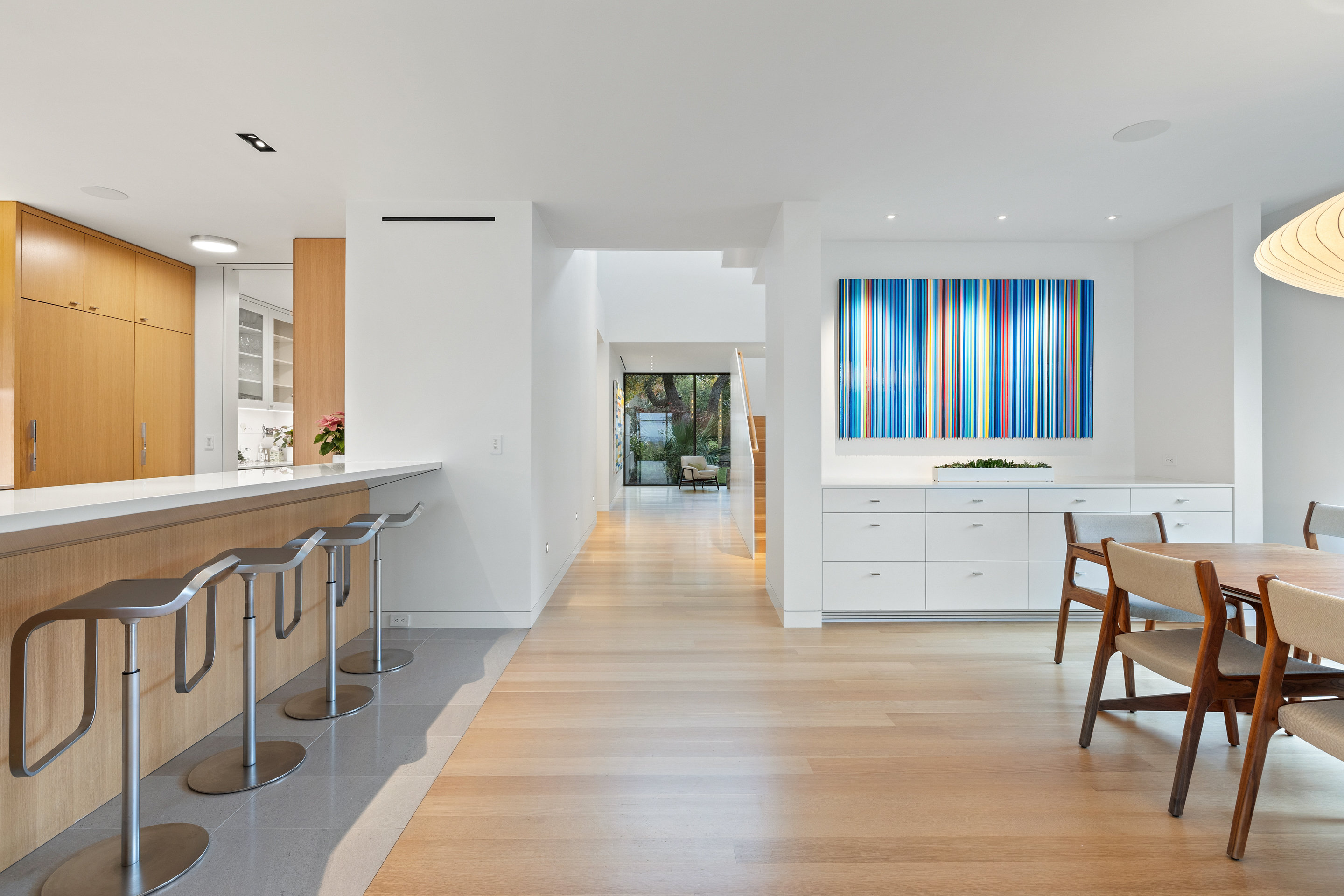 Full kitchen view with pendant lighting and bar seating