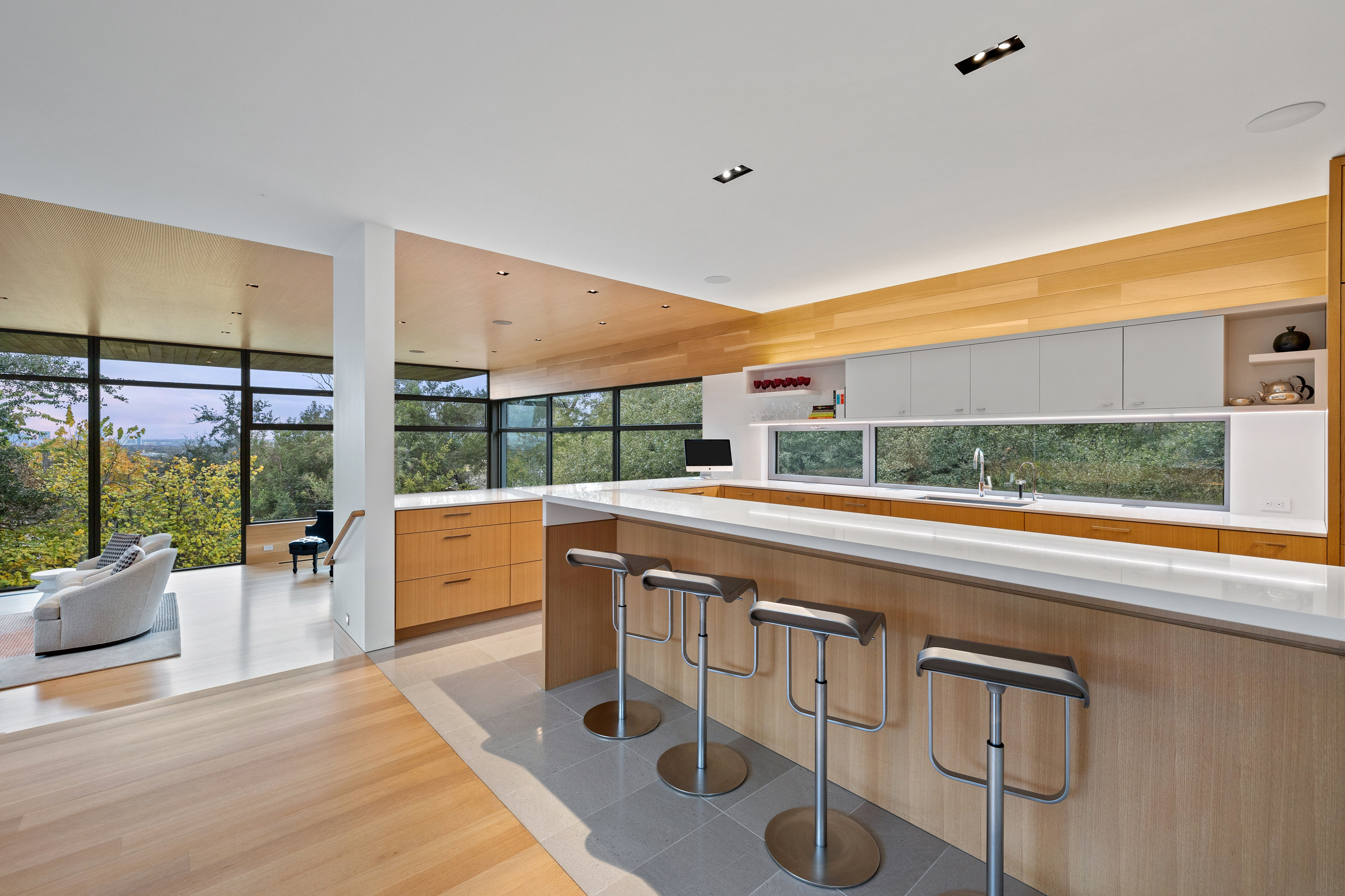 Kitchen island with white quartz counters and bar seating overlooking Hill Country