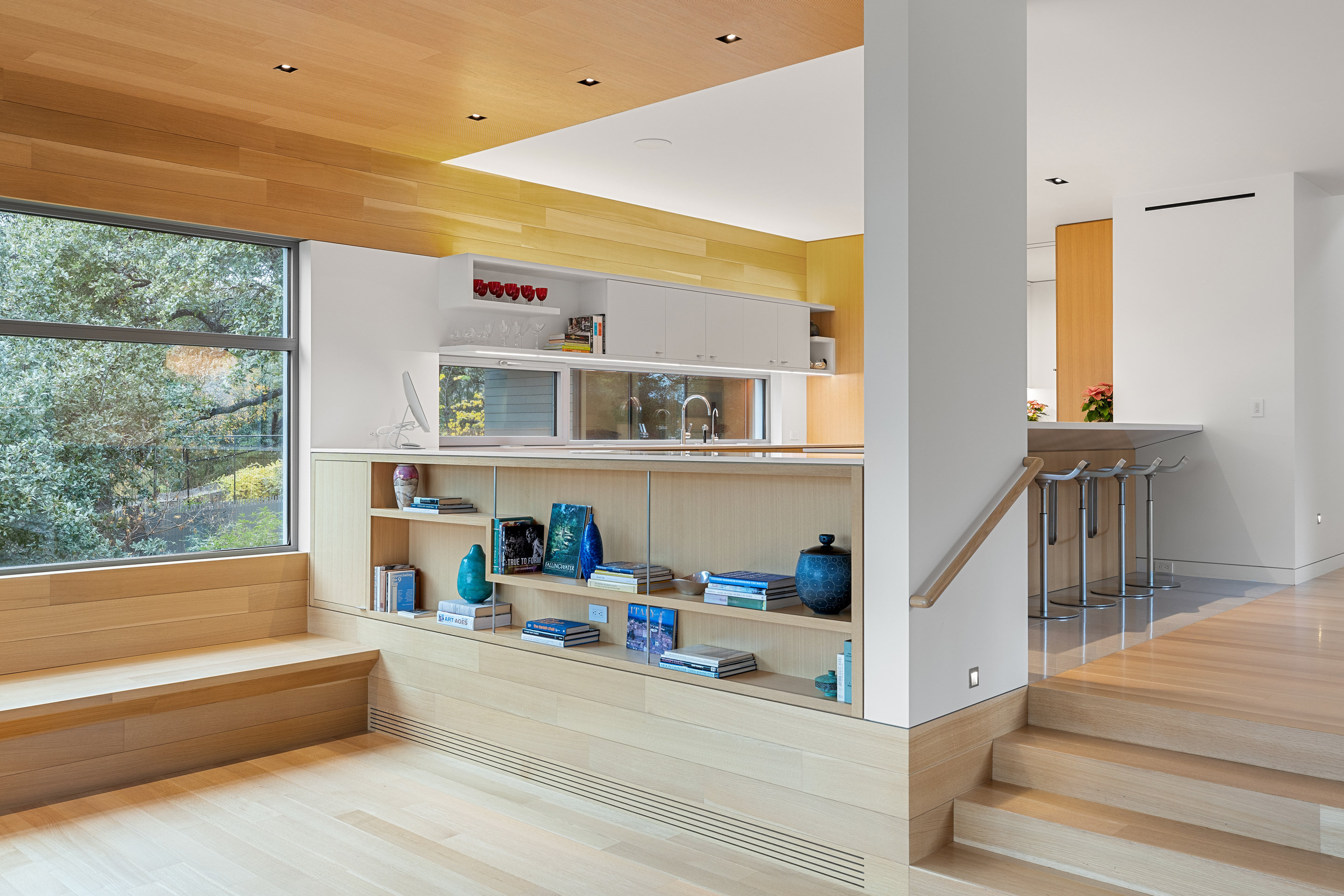 Dining area overlooking zen courtyard through floor-to-ceiling glass