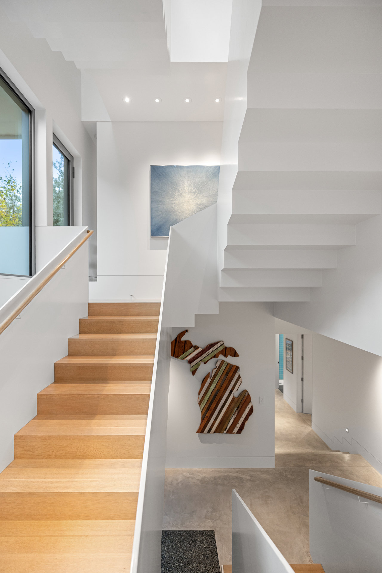 Primary bath vanity with integrated lighting and marble counter