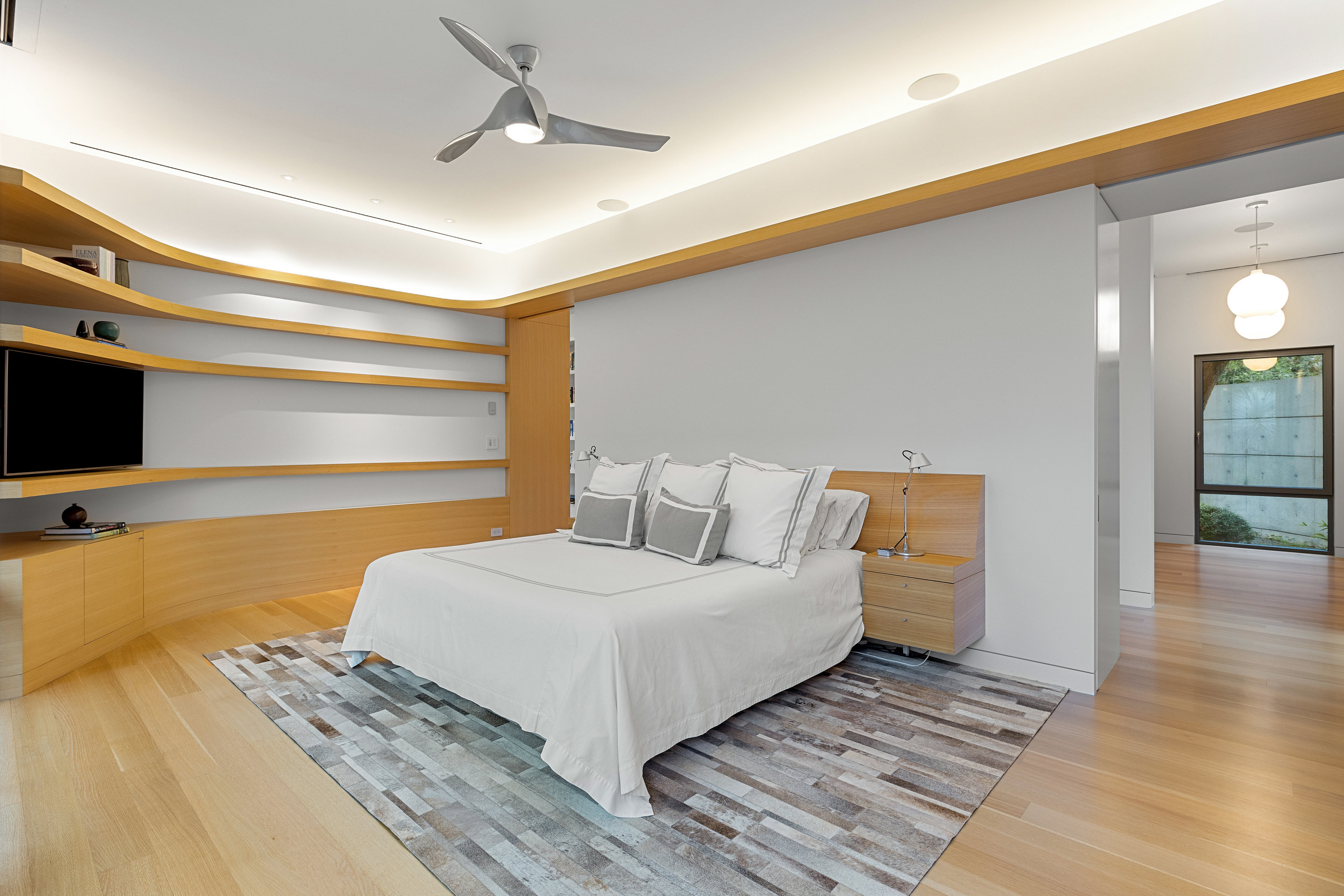 Wide exterior view from landscaped hillside at dusk