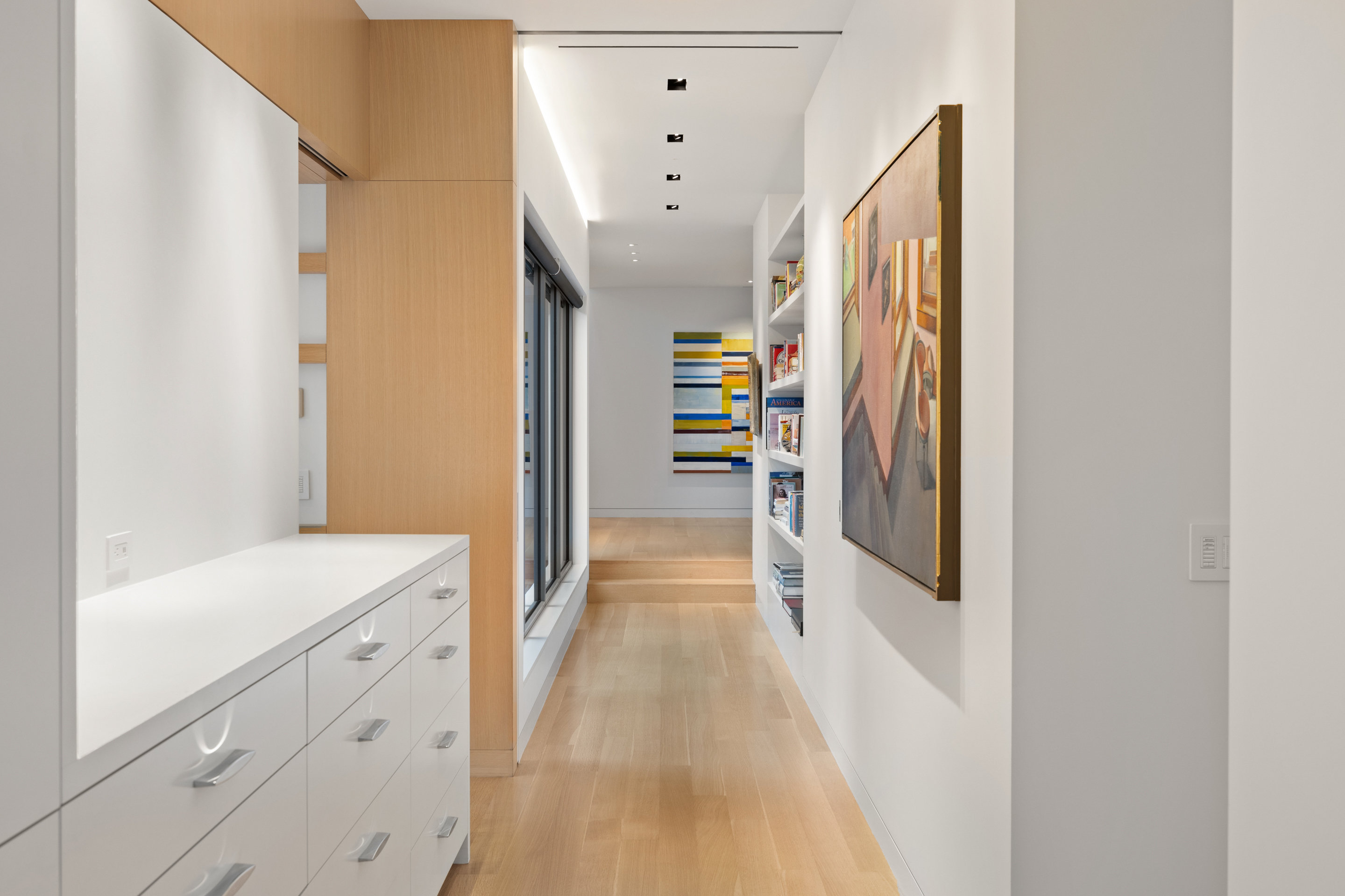 Guest bedroom with built-in white oak wardrobe and desk