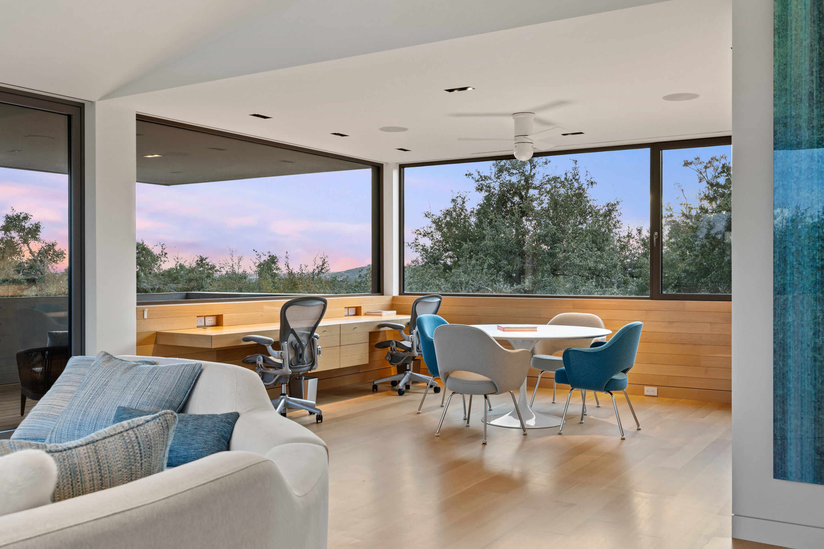 White oak built-in millwork with recessed skirting and cove lighting