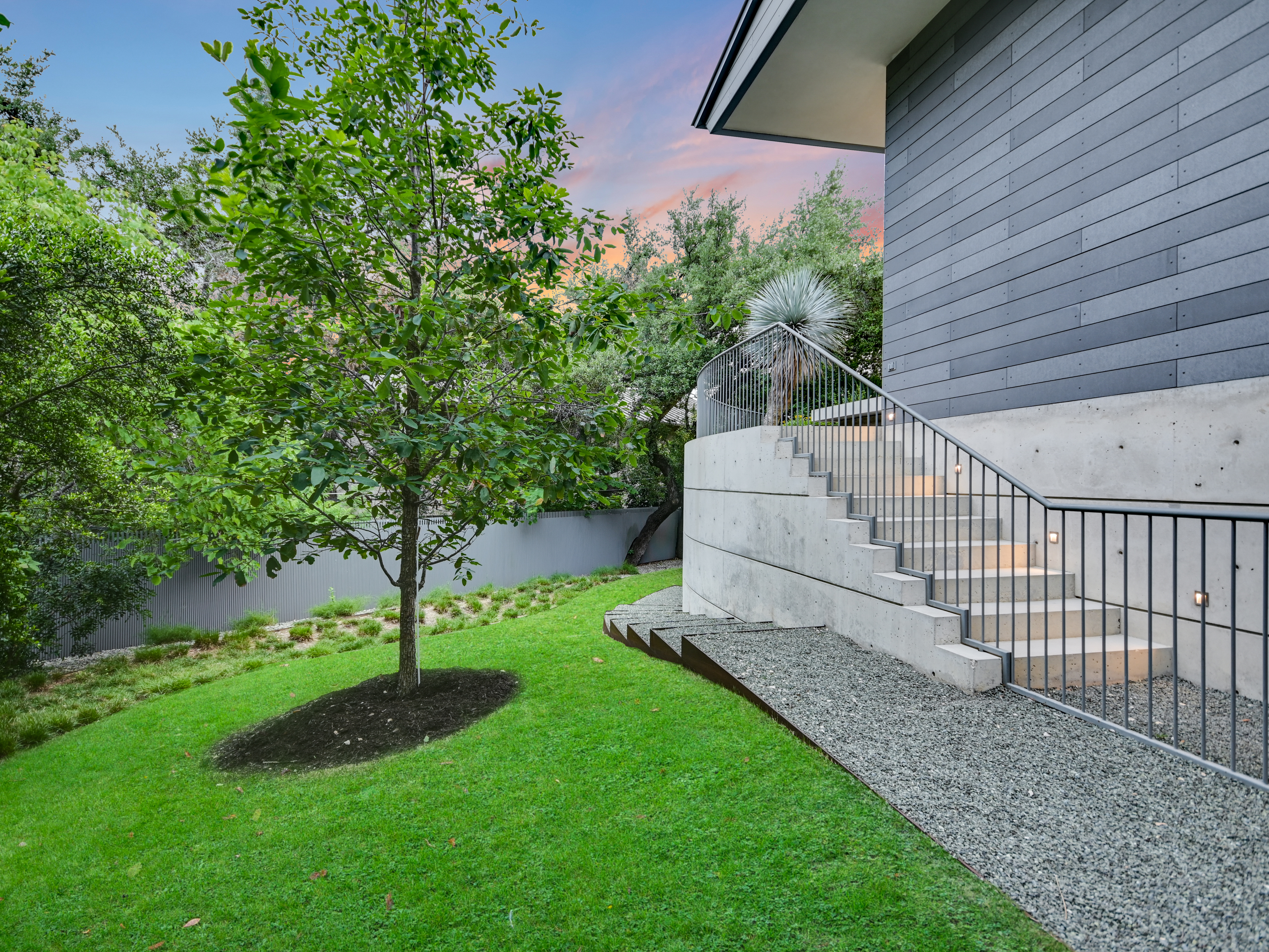 Stone steps descending through native garden to lower grounds
