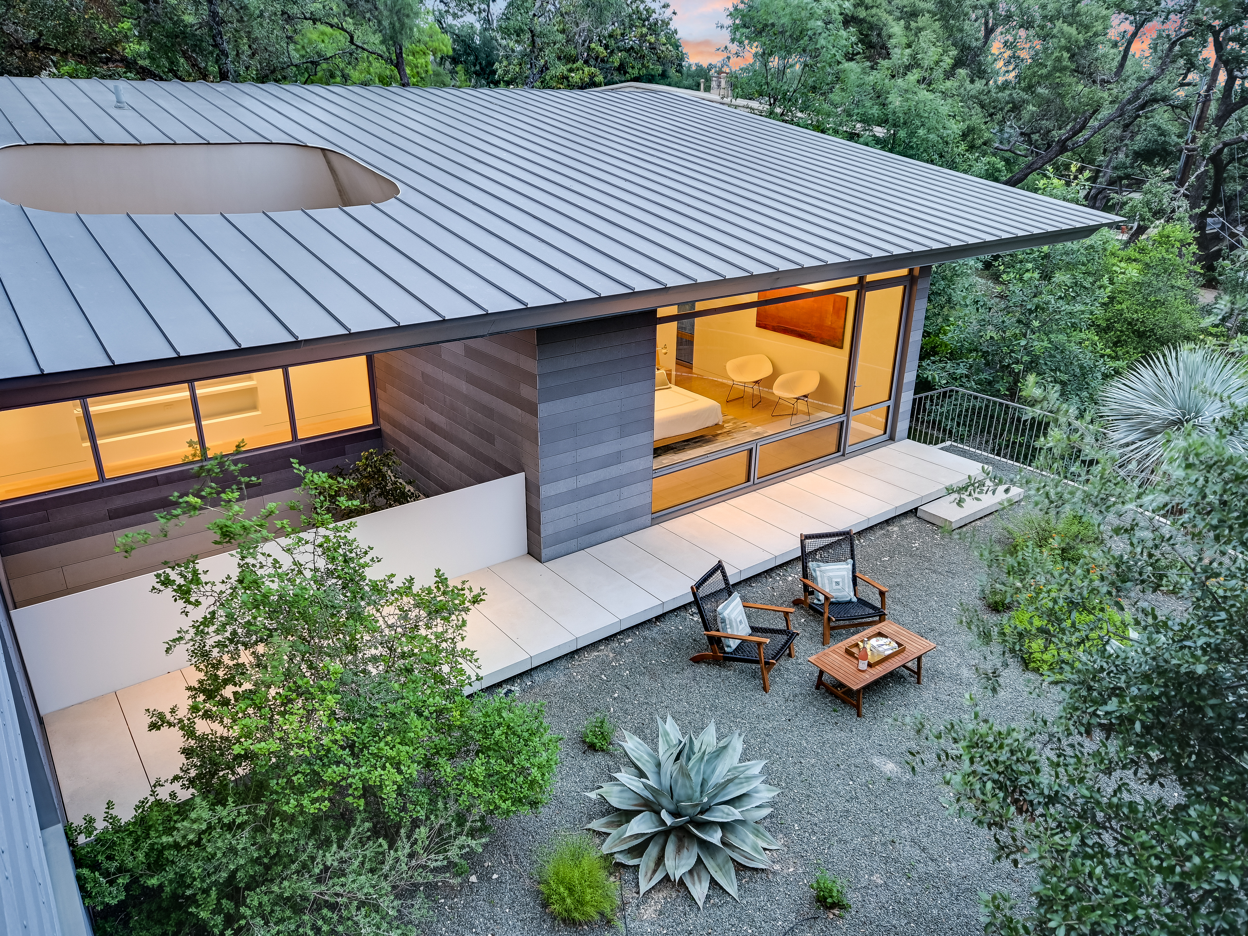 Courtyard view looking back toward glass-walled living spaces