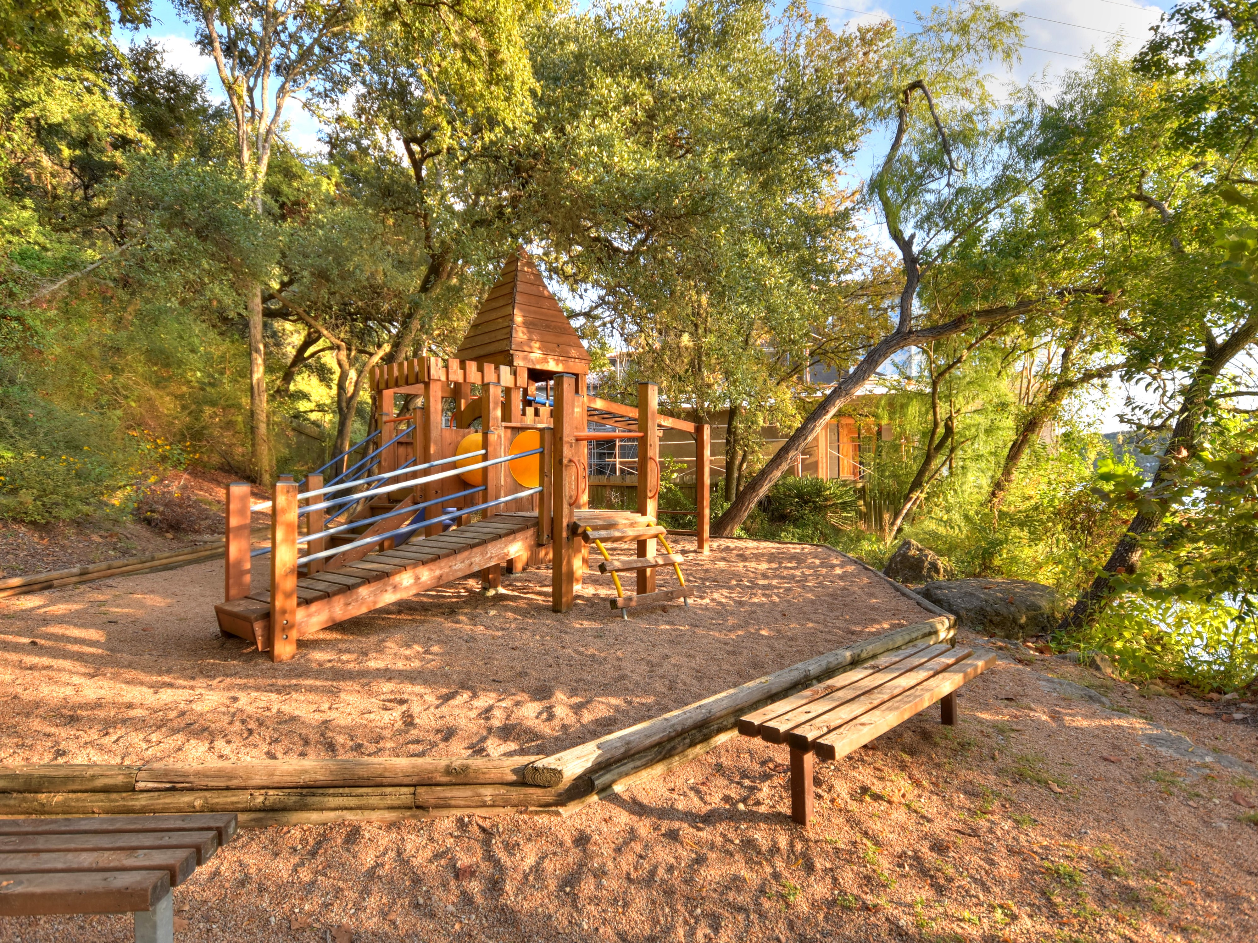 Natural playscape area with climbing structures
