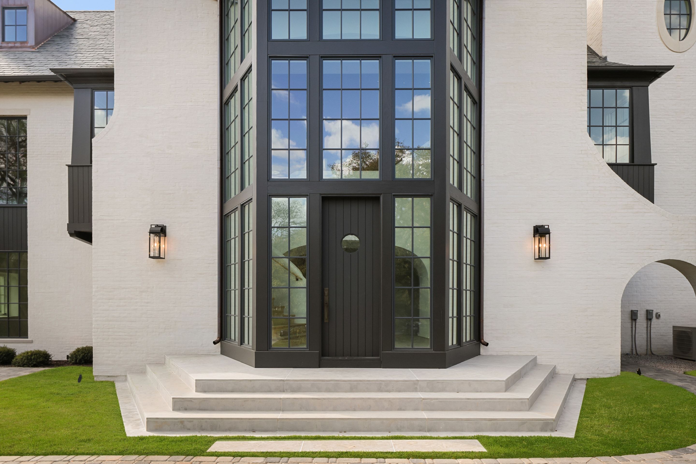 Two-story steel-framed entry with lanterns
