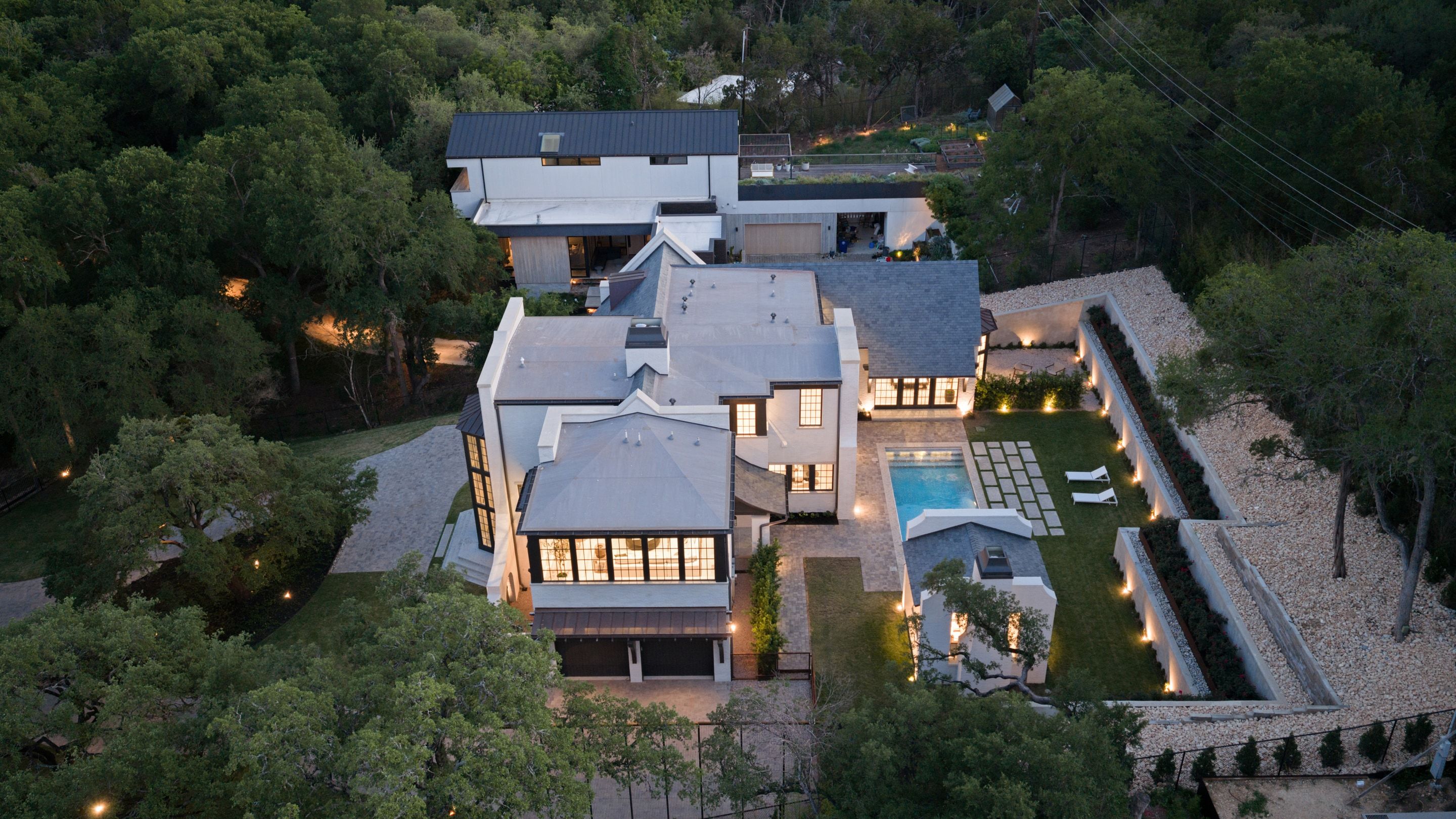 3802 Balcones Drive rear estate aerial dusk