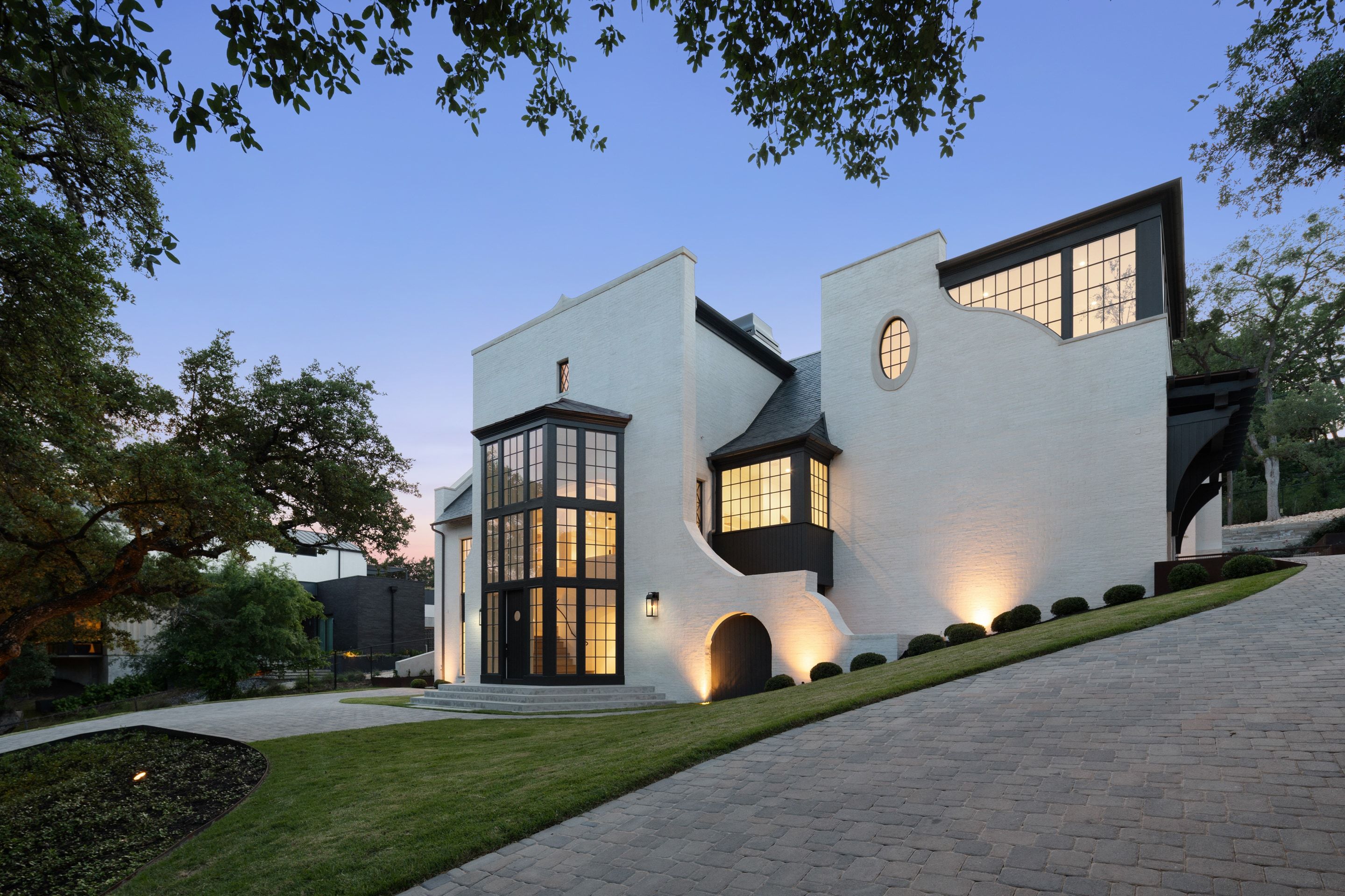 3802 Balcones Drive front exterior drive curve dusk