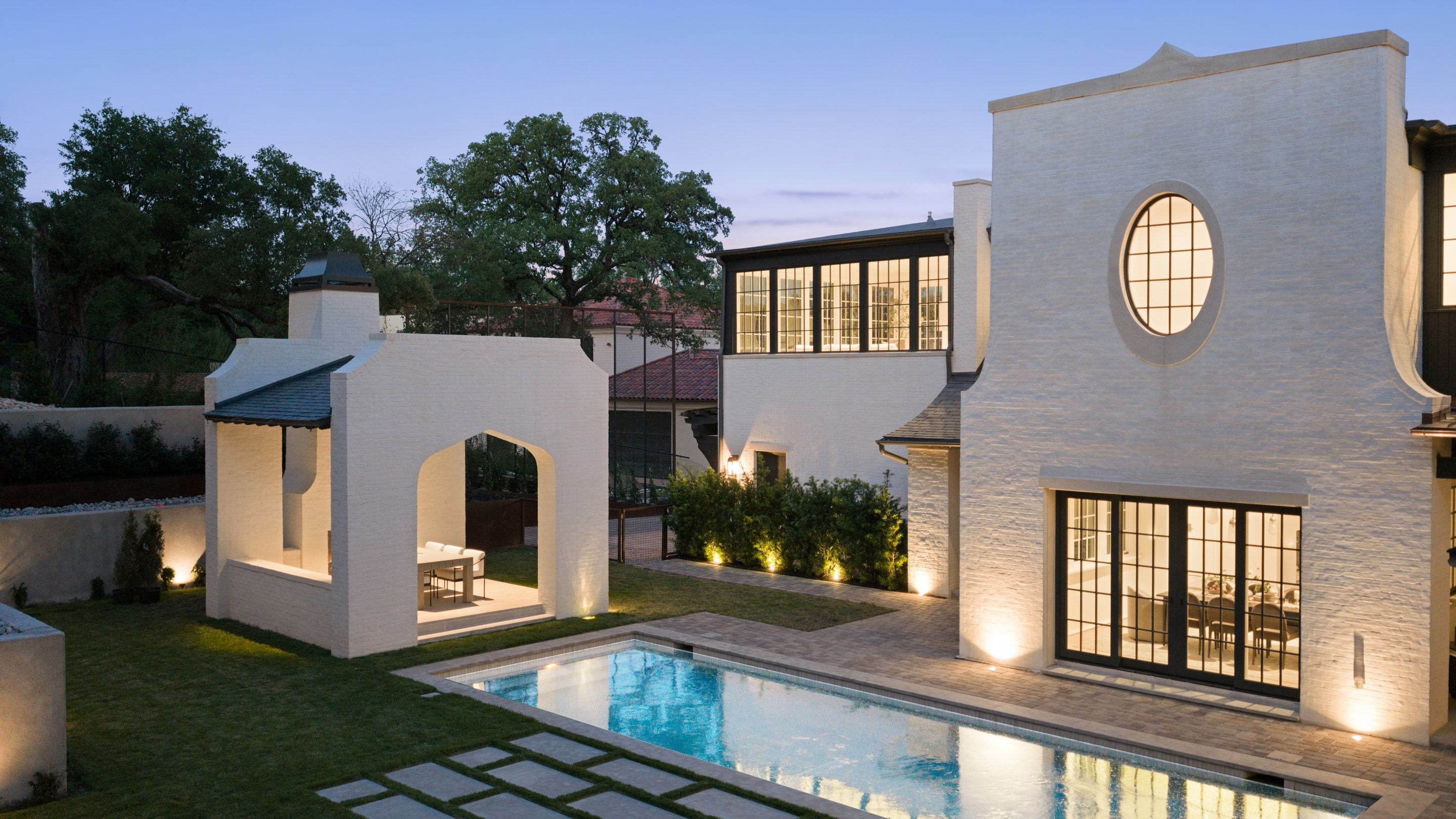 3802 Balcones Drive pool courtyard dusk aerial