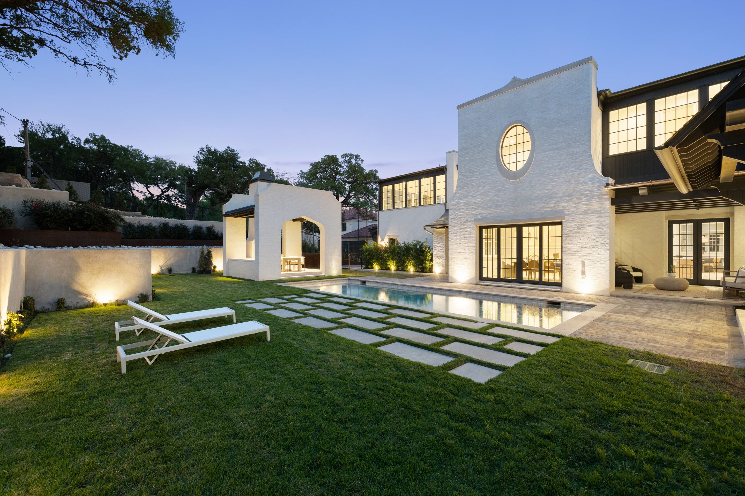 3802 Balcones Drive rear lawn and pool dusk