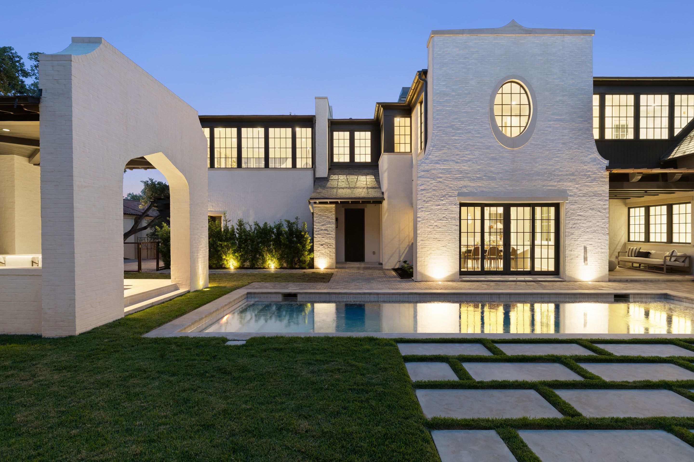 3802 Balcones Drive pool arch courtyard dusk