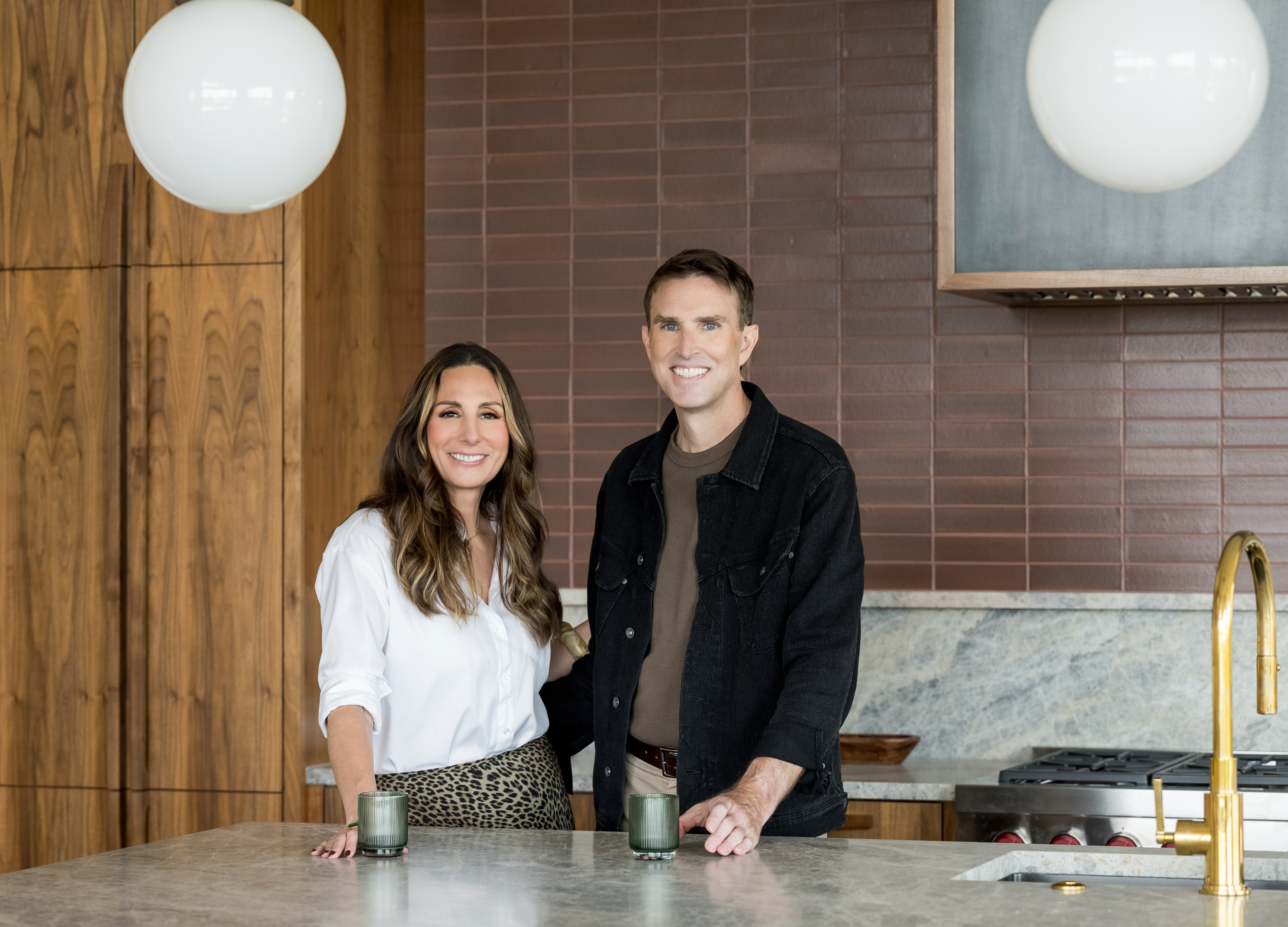 Joe and Cara Keenan standing together in a kitchen.