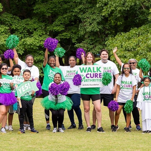 Participants holding a Walk to Cure Arthritis banner.