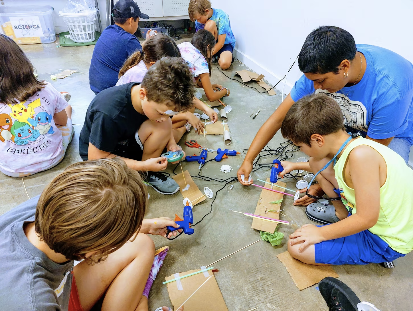 Children working with art materials around a table.