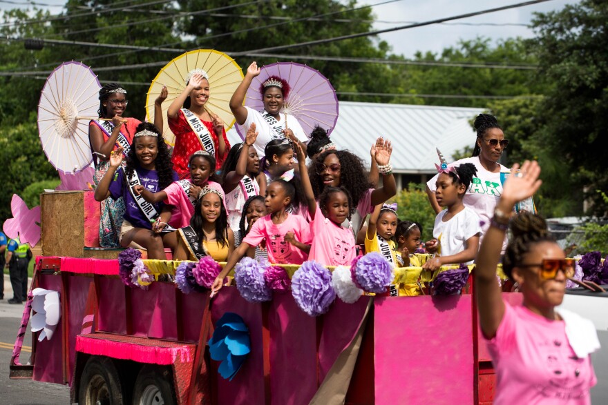 People on and beside a parade float.
