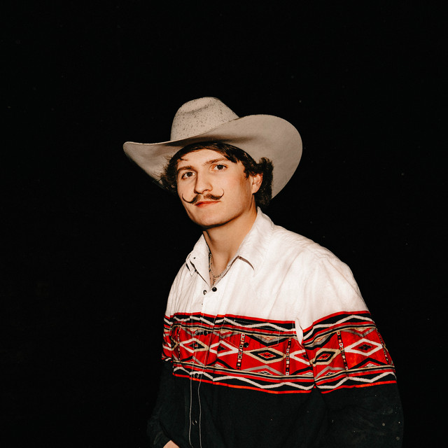 Braxton Keith in a cowboy hat and embroidered shirt.
