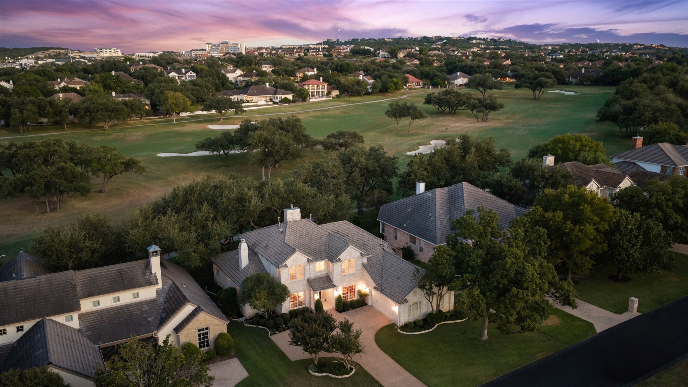 An aerial view at dusk of 34 Tiburon Drive beside a golf course fairway.